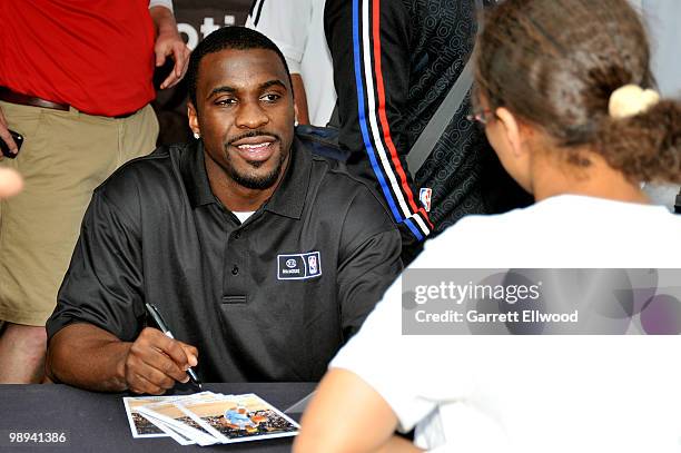 Ty Lawson of the Denver Nuggets signs autographs during the NBA Nation Mobile Basketball Tour on May 9, 2010 at the "Cinco De Mayo Festival" in...
