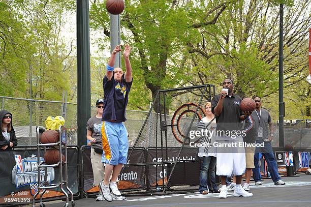 Ty Lawson of the Denver Nuggets talks to the crowd as a fan participates in the NBA Nation Mobile Basketball Tour on May 9, 2010 at the "Cinco De...