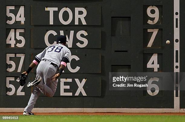 Marcus Thames of the New York Yankees misplays a ball hit by Jeremy Hermida of the Boston Red Sox at Fenway Park on May 9, 2010 in Boston,...