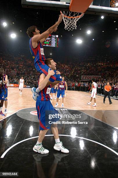 Ricky Rubio and Fran Vazquez of Barcelona celebrate cutting the net of the basket during the Euroleague Basketball Final Four Final Game between...