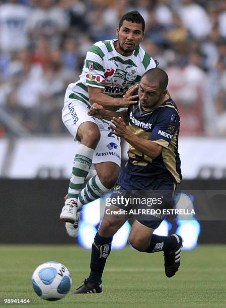 Pumas' Jehu Chiapas vies for the ball with Santos' Antonio Olvera , during the second leg of their Mexican Bicentenario Tournament quarterfinal...