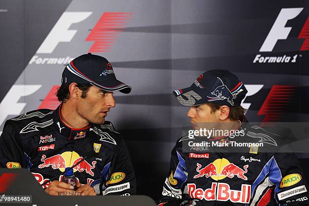 Mark Webber of Australia and Red Bull Racing is seen talking with team mate Sebastian Vettel of Germany and Red Bull Racing in the post race press...