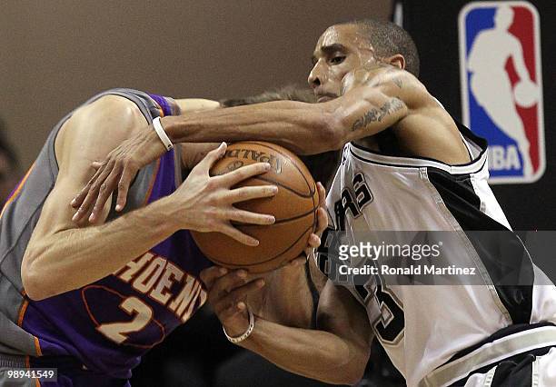 Guard George Hill of the San Antonio Spurs reaches for the ball against Goran Dragic of the Phoenix Suns in Game Four of the Western Conference...