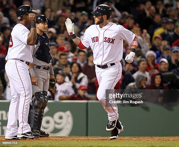Jeremy Hermida of the Boston Red Sox celebrates with teammate Adrian Beltre after hitting a home run against the New York Yankees in the fifth inning...