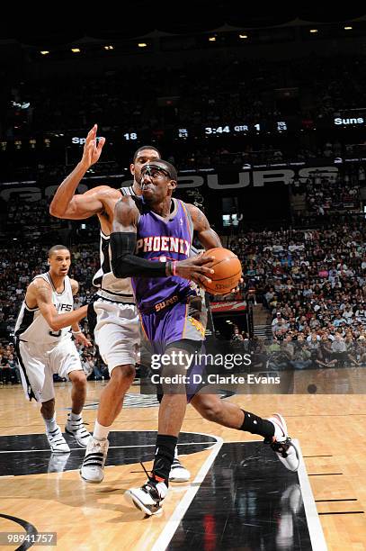 Amar'e Stoudemire of the Phoenix Suns drives against Tim Duncan of the San Antonio Spurs in Game Four of the Western Conference Semifinals during the...