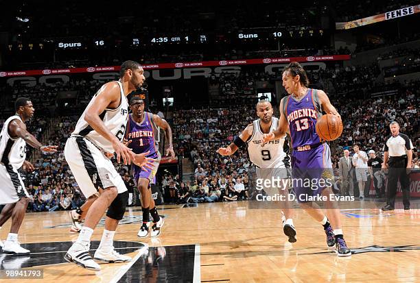 Steve Nash of the Phoenix Suns drives downcourt against Tony Parker and Tim Duncan of the San Antonio Spurs in Game Four of the Western Conference...