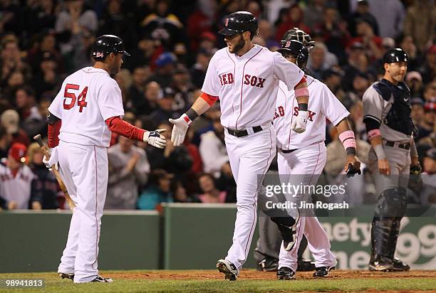 Jeremy Hermida of the Boston Red Sox celebrates with teammate Darnell McDonald after hitting a hoome run against the New York Yankees in the fifth...