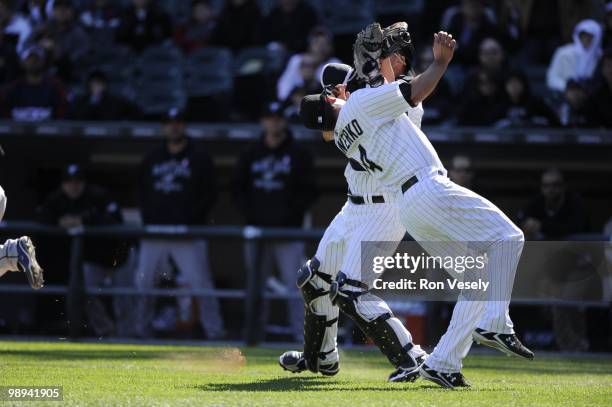 Paul Konerko hangs on to the ball to record the out after colliding with A.J. Pierzynski of the Chicago White Sox on a pop up by Alex Gonzalez the...