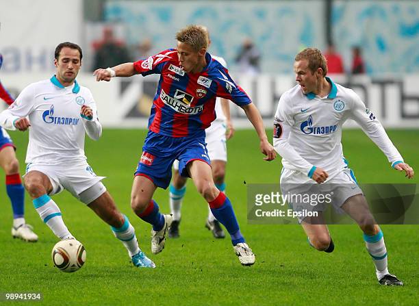 Keisuke Honda of PFC CSKA Moscow battles for the ball with Roman Shirokov and Aleksandr Anyukov of FC Zenit St. Petersburg during the Russian...