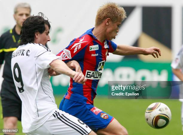 Keisuke Honda of PFC CSKA Moscow battles for the ball with Sergey Kovalchuk of FC Tom Tomsk during the Russian Football League Championship match...