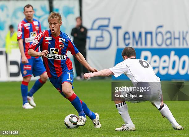 Keisuke Honda of PFC CSKA Moscow battles for the ball with Dmitri Michkov of FC Tom Tomsk during the Russian Football League Championship match...