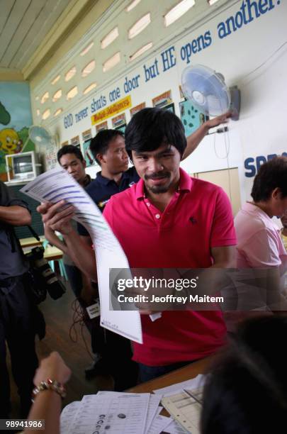 World welterweight boxing champion Manny Pacquiao, who is seeking a seat in the Philippine Congress with his party with the Nacionalista Party, holds...