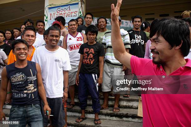 World welterweight boxing champion Manny Pacquiao, who is seeking a seat in the Philippine Congress with his party with the Nacionalista Party, waves...