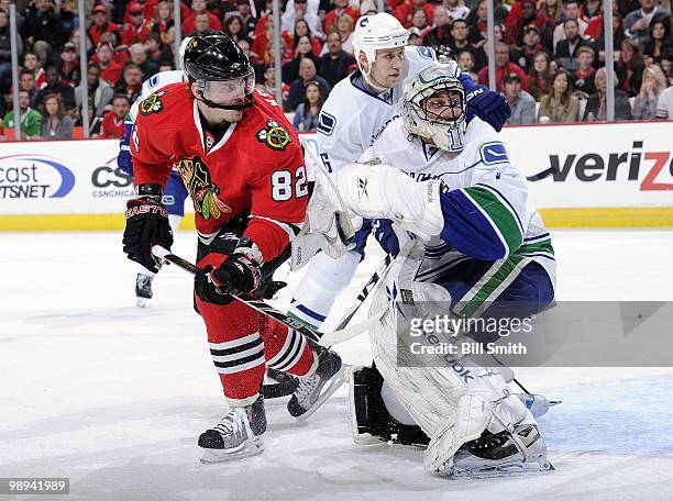 Vancouver Canucks goalie Roberto Luongo and Tomas Kopecky of the Chicago Blackhawks looks back for the puck as Sami Salo of the Canucks looks from...