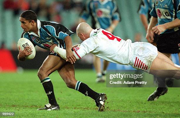 Preston Campbell for the Sharks is tackled by Paul McGregor for St George Illawarra during round 14 of the National Rugby League match played between...