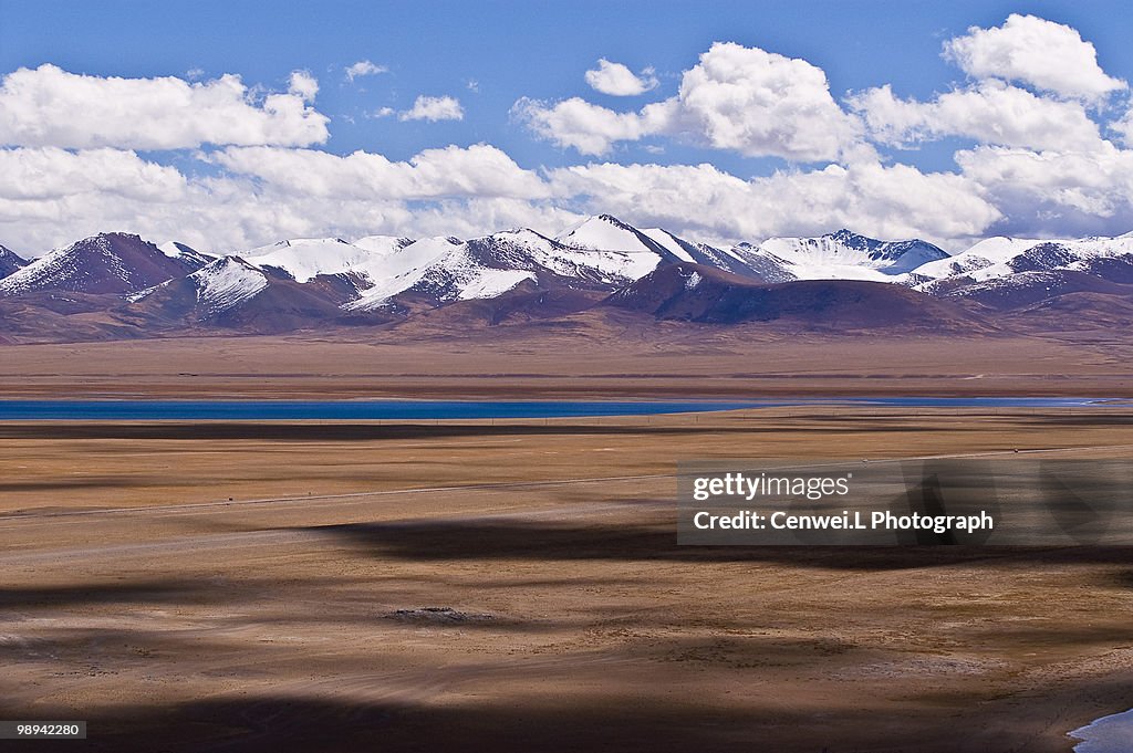 Snow capped mountains below clouds
