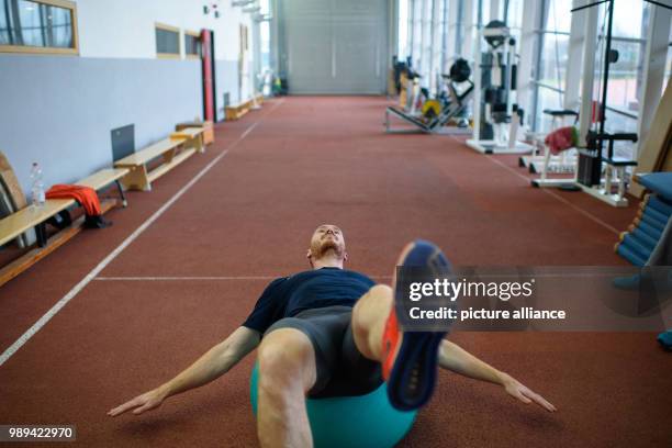 The discus thrower Christoph Harting trains on a exercise ball at the Olympic Training Centre in Berlin, Germany, 28 November 2017. Christoph Harting...