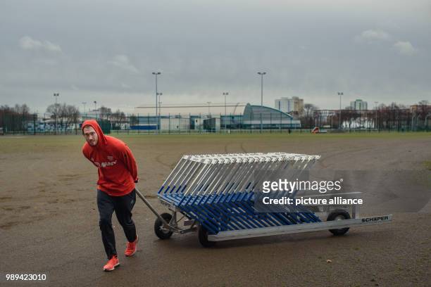 The discus thrower Christoph Harting pulls a wagon with hurdles before his training session at the Olympic Training Centre in Berlin, Germany, 28...