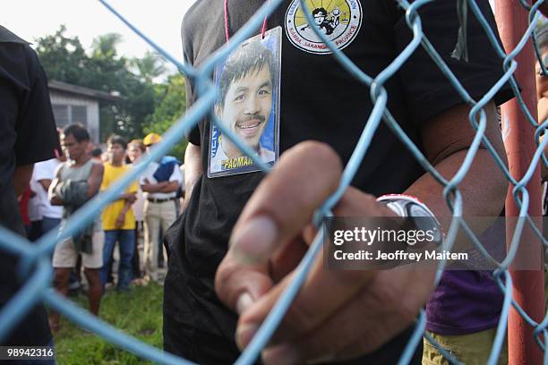 Filipino voters wait to enter a polling center to cast their votes on May 10, 2010 in the southern town of Kiamba, Sarangani Province. The country...