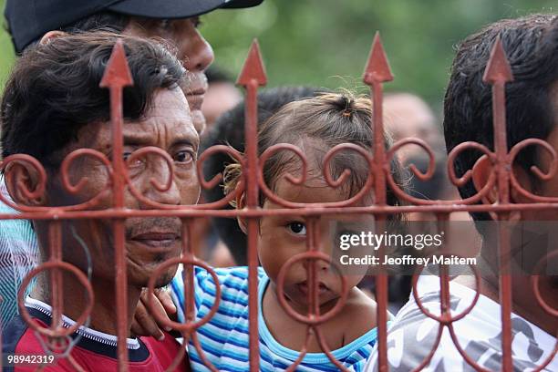 Filipino voters wait to enter a polling center to cast votes on May 10, 2010 in the southern town of Kiamba, Sarangani Province. The country goes to...