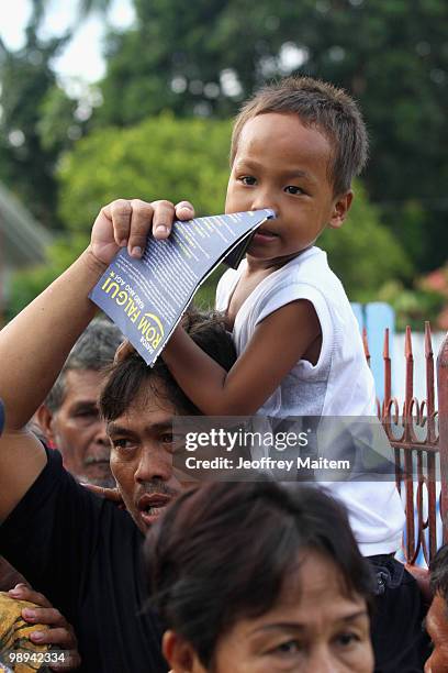 Filipino voters enter a polling center to cast votes on May 10, 2010 in the southern town of Kiamba, Sarangani Province. The country goes to the...