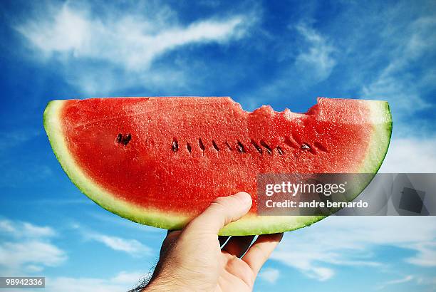 slice of watermelon with a bite taken - garopaba stock pictures, royalty-free photos & images