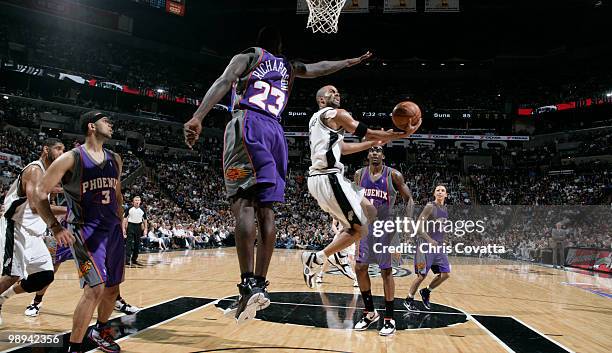 Tony Parker of the San Antonio Spurs shoots around Jason Richardson of the Phoenix Suns in Game Four of the Western Conference Semifinals during the...