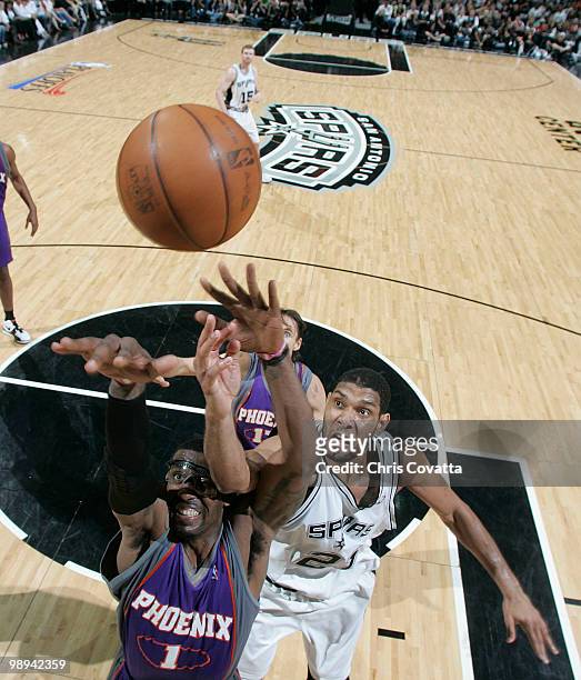 Tim Duncan of the San Antonio Spurs shoots over Amar'e Stoudemire of the Phoenix Suns in Game Four of the Western Conference Semifinals during the...