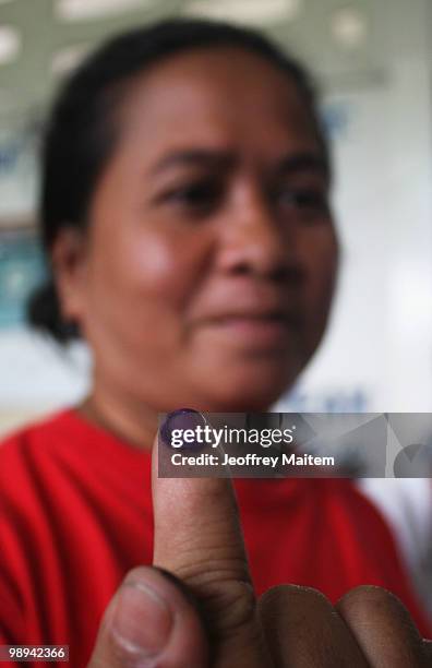 Filipina voter shows her inked finger after casting her ballot on May 10, 2010 in the town of Kiamba, Sarangani, Philippines. The country goes to the...