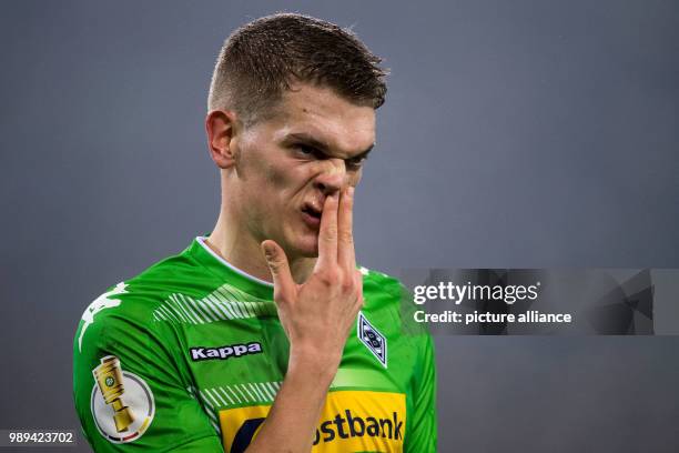 Gladbach's Matthias Ginter touches his nose during the German DFB Cup soccer match between Borussia Moenchengladbach and Bayer Leverkusen in...