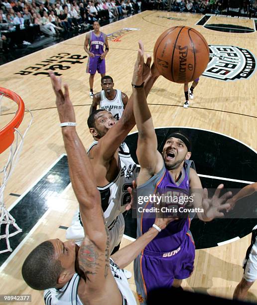 Tim Duncan of the San Antonio Spurs blocks a shot by Jared Dudley of the Phoenix Suns in Game Four of the Western Conference Semifinals during the...