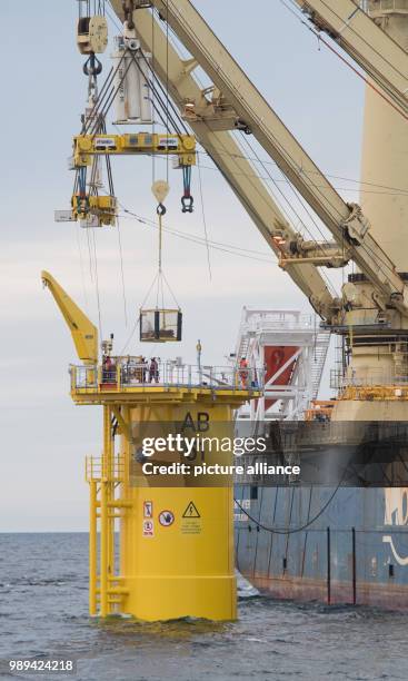 Special ship assembles transition pieces between foundation piles in the Baltic Sea and facilities of the wind farm 'Arkona' off the coast of the...