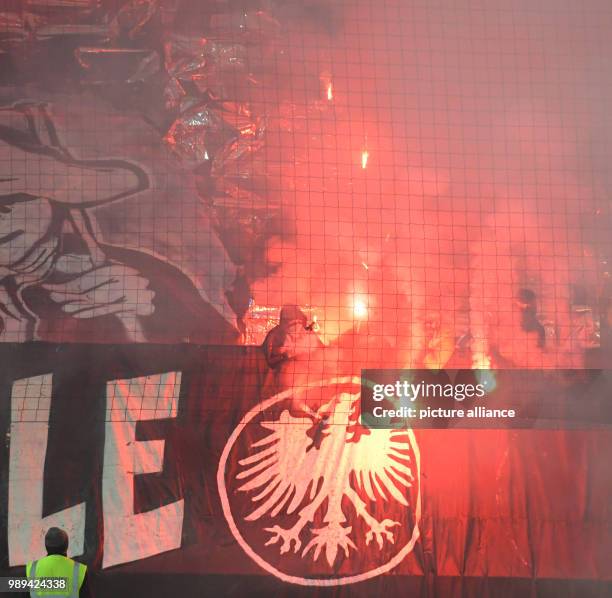 Frankfurt's fans ignite pyrotechnics during the German DFB Cup soccer match between 1. FC Heidenheim and Eintracht Frankfurt in the Voith-Arena in...