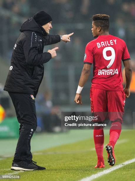 Leverkusen's coach Heiko Herrlich speaks to Leon Bailey during the German DFB Cup soccer match between Borussia Moenchengladbach and Bayer Leverkusen...