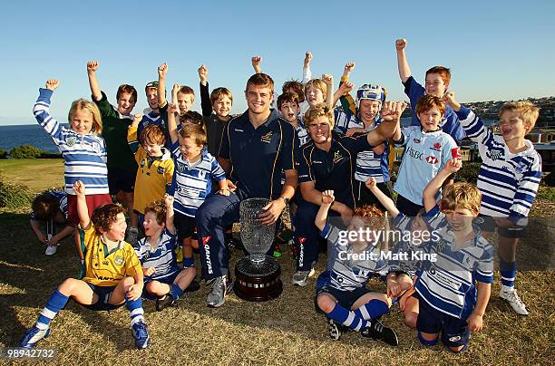 Dean Mumm and Berrick Barnes pose with the Cook Cup and local ruby playing children during an ARU press conference to announce the sale of tickets...