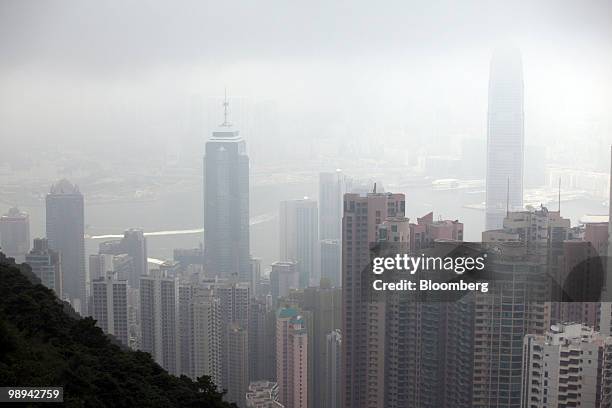 High rise buildings blanketed in haze tower above Victoria Harbor in Hong Kong, China, on Friday, May 7, 2010. Hong Kong's air pollution was the...