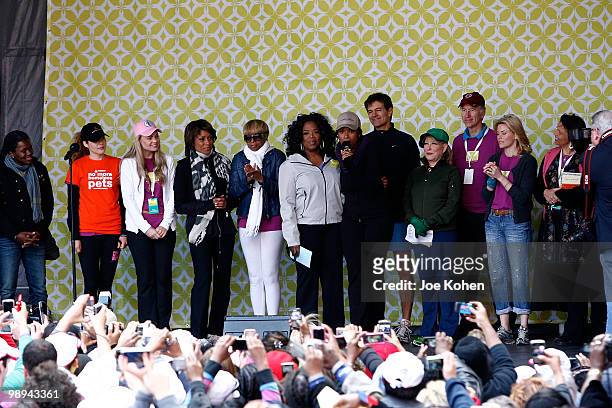 Oprah Winfrey stands on stage with Elizabeth Banks, Tracy Chapman, Mary J. Blige, Jennifer Hudson, Bette Midler and Dr. Mehmet Oz at the finish line...