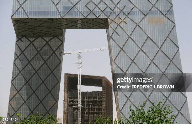 The burnt exterior of what was to be the Mandarin Oriental hotel in a building at the new headquarters of China Central Television that was gutted in...