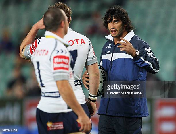 An injured Johnathan Thurston of the Cowboys watches on during the warm-up before the round nine NRL match between the Sydney Roosters and the North...