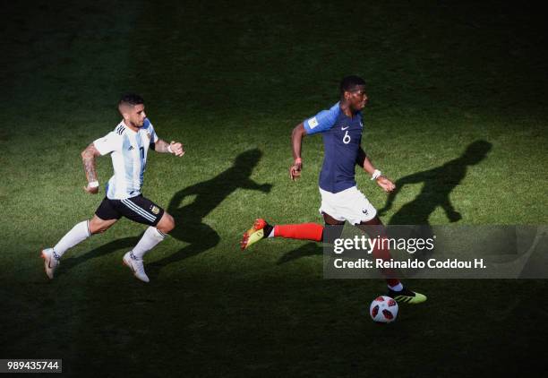 Paul Pogba of France and Ever Banega of Argentina are seen during the 2018 FIFA World Cup Russia Round of 16 match between France and Argentina at...