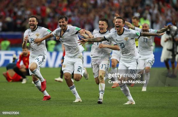 Vladimir Granat , Aleksandr Erokhin, Aleksandr Golovin and Fyodor Smolov of Russia celebrates when they win the penalty shoot out during the 2018...