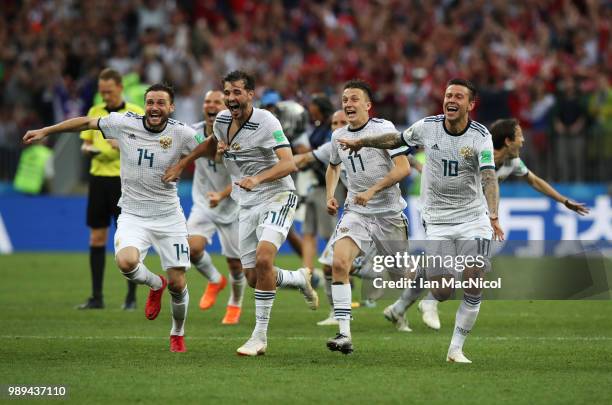 Vladimir Granat , Aleksandr Erokhin, Aleksandr Golovin and Fyodor Smolov of Russia celebrates when they win the penalty shoot out during the 2018...