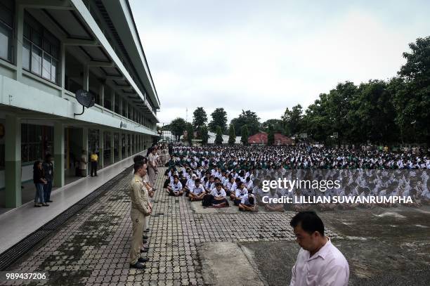 Thai school children pray for their missing classmates from the grounds of Mae Sai Prasitsart school, near Tham Luang cave in Khun Nam Nang Non...