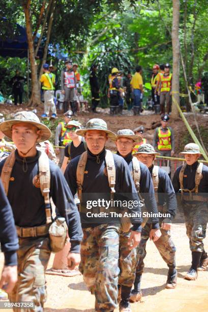 Rescue workers carry heavy water pumping equipments into Tham Luang Nang Non cave on July 1, 2018 in Chiang Rai, Thailand. Rescuers in northern...