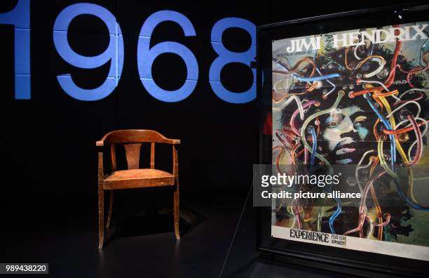 Wooden chair on which Jimi Hendrix supposedly sat on in 1969 is exposed next to a poster of himas the Medusa of cables by Guenther Kieser in the...