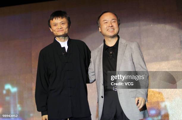 Ma Yun , chairman of the Alibaba Group and Masayoshi Son, Chairman and CEO of the Softbank Corportation pose for photos during the press conference...