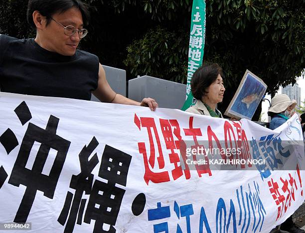 Protesters stage a demonstration with a banner demanding "We do not allow base construction on Henoko" refering to a controversial US airbase in...