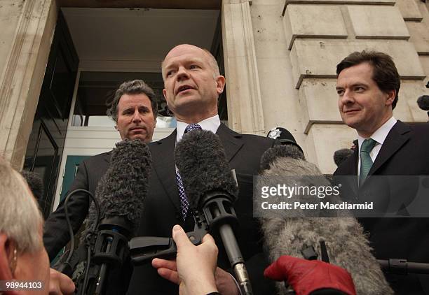 Conservative Party negotiators Oliver Letwin, William Hague and George Osborne talk to reporters outside The Cabinet Office before holding coalition...