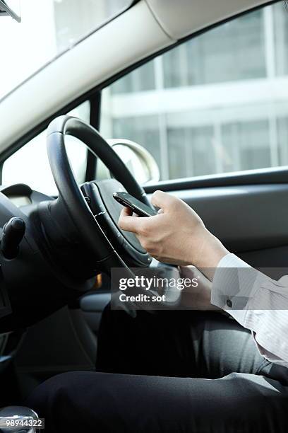 businessman using pda in car,close up - newbusiness stock pictures, royalty-free photos & images