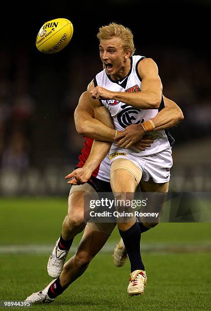 Dennis Armfield of the Blues handballs whilst being tackled by Adam Schneider of the Saints during the round seven AFL match between the St Kilda...